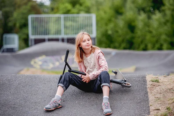 Preteen Girl Scooter Sitting City Park Spring Time Looking Camera — Stock Photo, Image