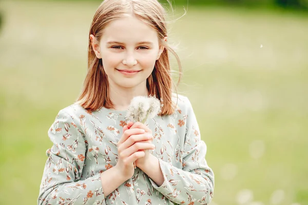 Little Girl Holding Blowballs Flower Hands Blossom Field Smiling Cute — стоковое фото