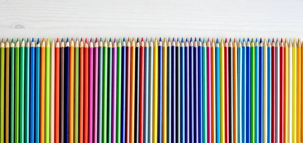 Colorful Pencils Lying Watercolor Paper Closeup Multicolor Crayons Pallete Artist — Fotografia de Stock
