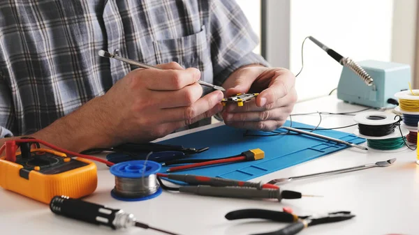Master Repairs Microchip In Repair Workshop