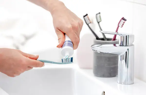 Girls Hand Applies Toothpaste Brush Hygiene Pristine White Bathroom — Stock Photo, Image