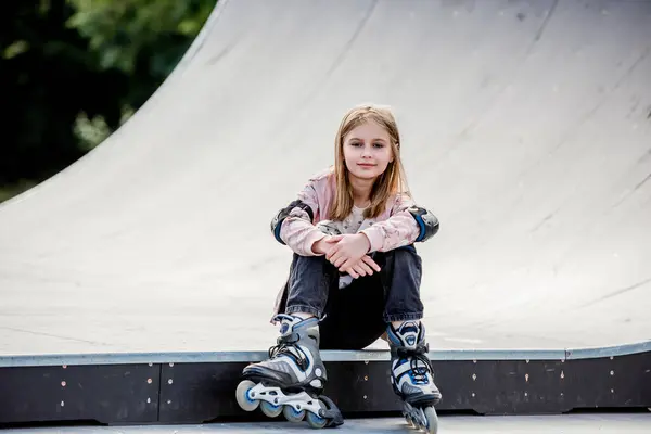 Cute Girl Roller Skater Sitting City Park Looking Camera Pretty – stockfoto