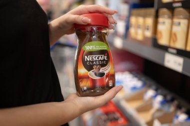 Poznan, Polonya - 29 Haziran 20224: Girl Holding Jar of Nescafe Classic Instant Coffee