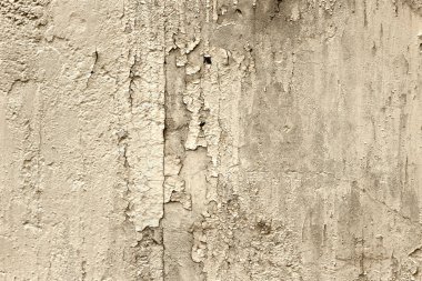 Rough texture of a concrete wall with peeling old paint, vintage background