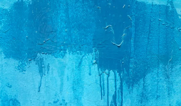 Bright blue painted wall texture with stains and smudges