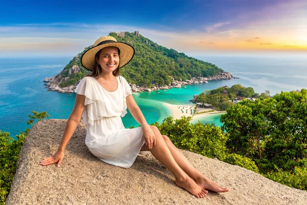 stock image Woman traveler wearing white dress and straw hat at Nang Yuan Island, Koh Tao, Thailand in a summer day