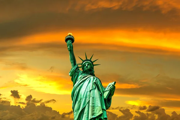 stock image Statue of Liberty against sunset sky with beautiful cloud background in New York City, NY, USA