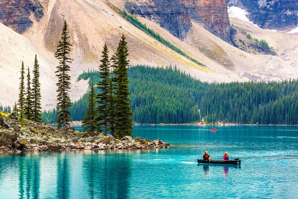 LAKE MORAINE, CANADA - APRIL 2, 2020: Tourists Canoeing on Lake Moraine, Banff National Park Of Canada