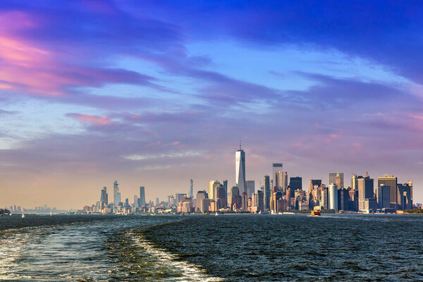 Cruise wash foam in Hudson river and Panoramic view of Manhattan cityscape in New York City at sunset, NY, USA
