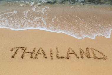 Tayland sözü Tayland 'da tropikal bir plajda yazılmış.