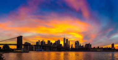Brooklyn Köprüsü 'nün Sunset Manzarası ve New York City, ABD' deki Manhattan şehir merkezinin panoramik manzarası.
