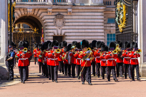 LONDON, UK - JUNE 17, 2022: Changing of the Guard ceremony in front of Buckingham Palace in London in a sunny summer day, UK