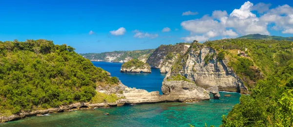 stock image Panorama of  Natural Rock Arch in Ocean Water and Atuh Beach viewpoint in Nusa Penida island, Bali, Indonesia