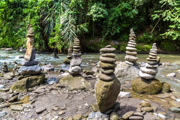 Balanced stones by the river in a summer day
