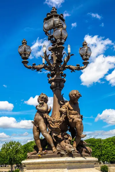 Bronze sculpture on the Bridge Pont Alexandre III in Paris in a summer day, France