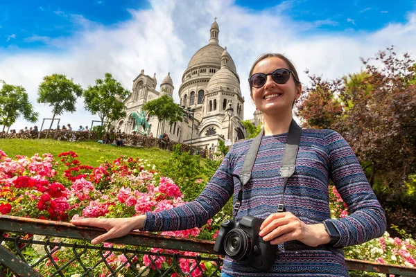 Woman traveler at Basilica of the Sacred Heart at Montmartre hill in Paris (Basilica of Sacre Coeur) in a summer day, France