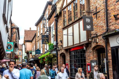 YORK, UK - AUGUST 28, 2023: The Shambles - a medieval street in Old Town in York in a summer day, North Yorkshire, UK clipart