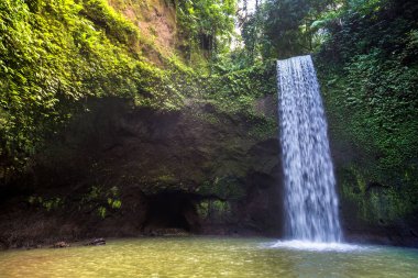 Tibumana waterfall in Bali, Indonesia in a sunny day clipart