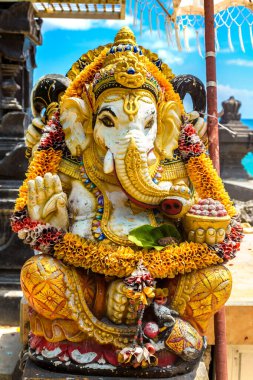 Traditional balinese Ganesha statue at beach on Bali in a sunny day, Indonesia