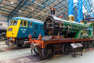 YORK, İngiltere - 6 Şubat 2025: D sınıfı buharlı lokomotifin yan yana görüntüsü No. 737 (1901) ve British Rail Class 84 elektrikli lokomotif No. York Demiryolu Müzesi 'nde 84 001.