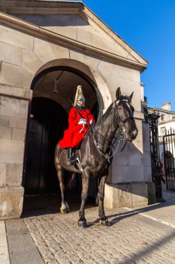 LONDON, İngiltere - 30 Ocak 2025: Atlı Süvari Birliği 'nin bir muhafızı, Atlı Muhafızlar Geçit Töreni' nin resmi girişi olan Londra 'daki Horse Guards Parade' da at sırtında oturuyor.
