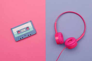 Pembe arka planda mavi ses kaseti ve menekşe arka planda pembe kulaklık. Analog ses müzik kavramı