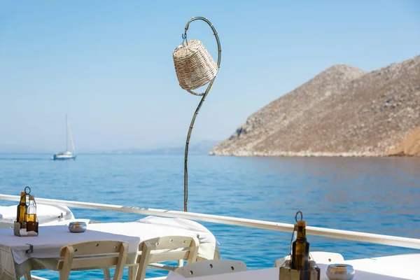 Tables on a terrace in a  restaurant with a sea view on a mediterrainian sea.