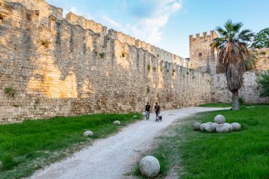 RHODES, GREECE - AUGUST 20, 2015: People walking around the walls of Medieval castle in old town of Rhodes island, Greece