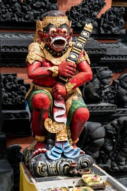 Stone colorful statues at the temple's entrance in Nusa Dua, Bali, Indonesia. Spiritual cullture symbols concept