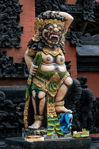 Stone colorful statues at the temple's entrance in Nusa Dua, Bali, Indonesia. Spiritual cullture symbols concept