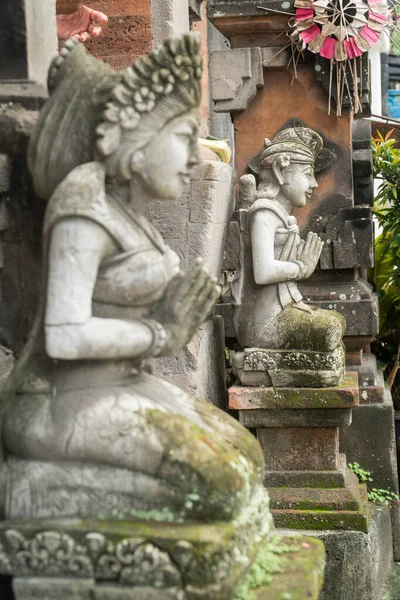 Stone statue with hands in a praying atthe temple\' entrance on Bali, Indonesia. Spiritual cullture symbols concept