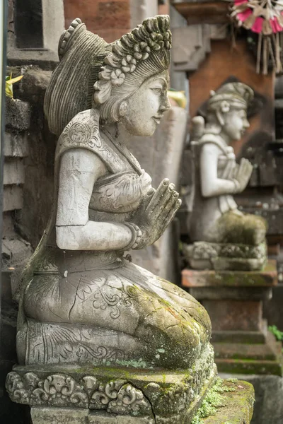 Stone statue with hands in a praying atthe temple\' entrance on Bali, Indonesia. Spiritual cullture symbols concept