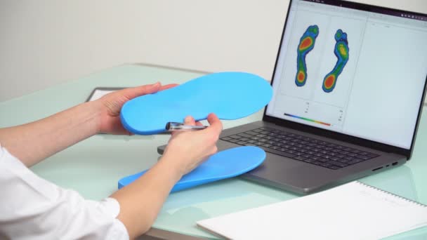 Női Orvos Ortopéd Fogvatartó Egyéni Készült Talpbetét Egy Klinikán Laptop — Stock videók