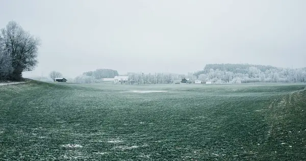 panorama of fields and a farm in winter, a beautiful landscape of Germany. Farmers in Germany