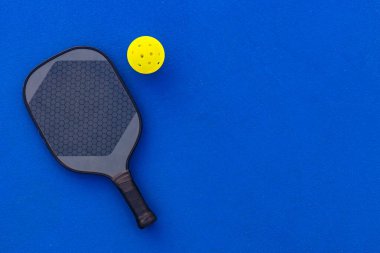 Pickleball tenis raketi sahada. Spor sahası ve toplar. Bir spor uygulaması ya da sosyal medya reklamının tasarımı için raketli yüksek kaliteli bir fotoğraf indir