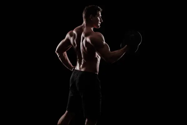 Junger Starker Mann Bodybuilder Hintergrund Mit Lichtern lizenzfreie Stockbilder