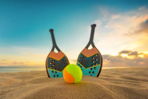 Beach tennis rackets. Sport court and balls. Download a high quality photo with paddle for the design of a sports app or social media advertisement