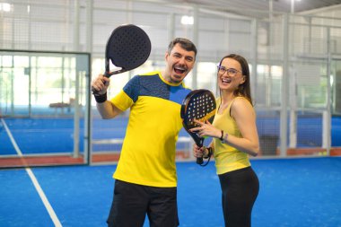 Raketli Padel tenisçi. Sahada raketi olan kız sporcu. Spor konsepti. Bir spor uygulaması ya da web sitesi tasarımı için yüksek kaliteli bir fotoğraf indir