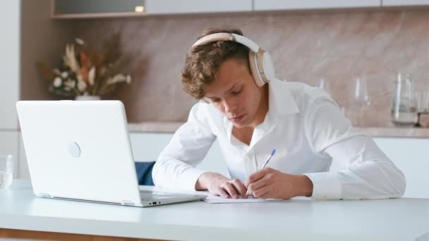 Young Adult Watching Video Course Making Notes Student Wearing Headphones — Stock Video