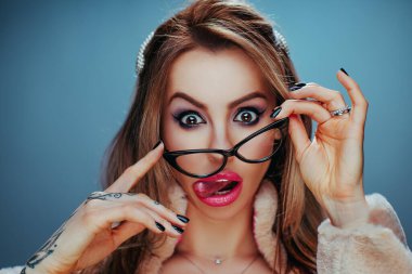 Young woman with glasses emotional studio portrait