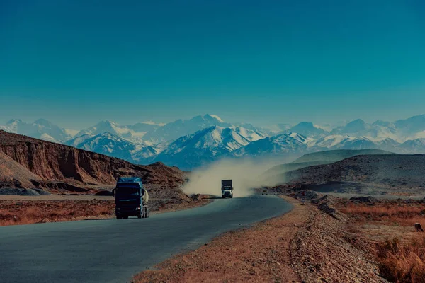 Trucks on high mountains road, Kyrgyzstan
