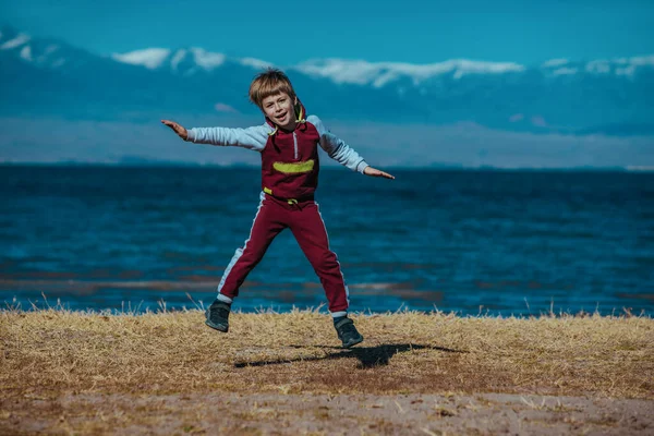 Rapaz Feliz Saltar Fundo Lago Issyk Kul Quirguizistão — Fotografia de Stock