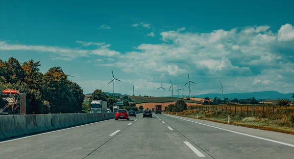 带风力涡轮机的公路和田野景观 — 图库照片