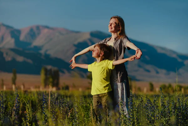 Happy Young Woman Her Son Posing Blooming Meadow Mountains Background — Stock Photo, Image