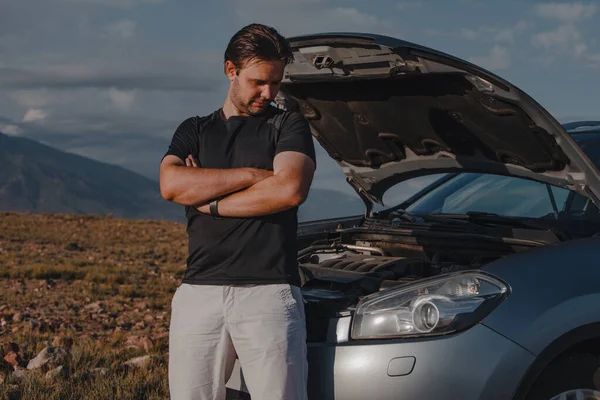 Sad Young Man Standing Front Broken Car Mountains Background — Stock Photo, Image