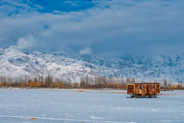 冬の山の背景に古い錆びたワゴン — ストック写真