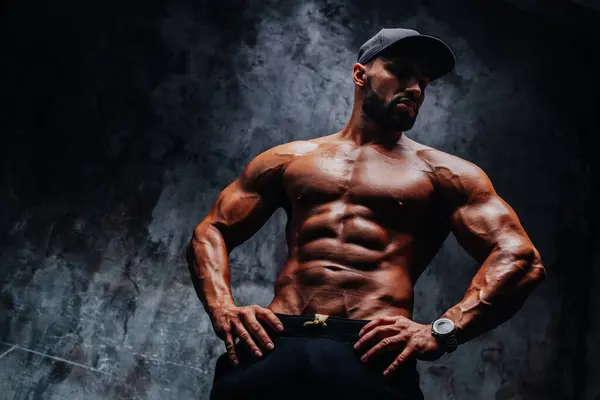 Young Strong Man Bodybuilder Cap Stone Wall Background Stock Image