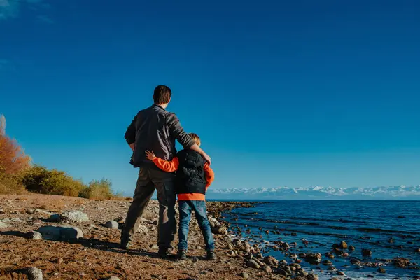 Father Son Standing Together Shore Lake Back View Royalty Free Stock Photos