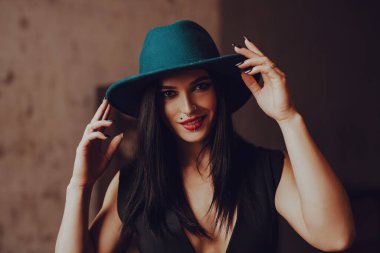 Şapka portresindeki zarif esmer kadın, sıcacık renkler.