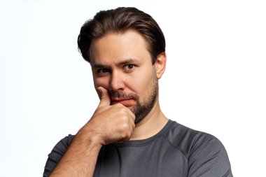 Beyaz arka planda genç düşünceli ve şüpheci bir adam portresi